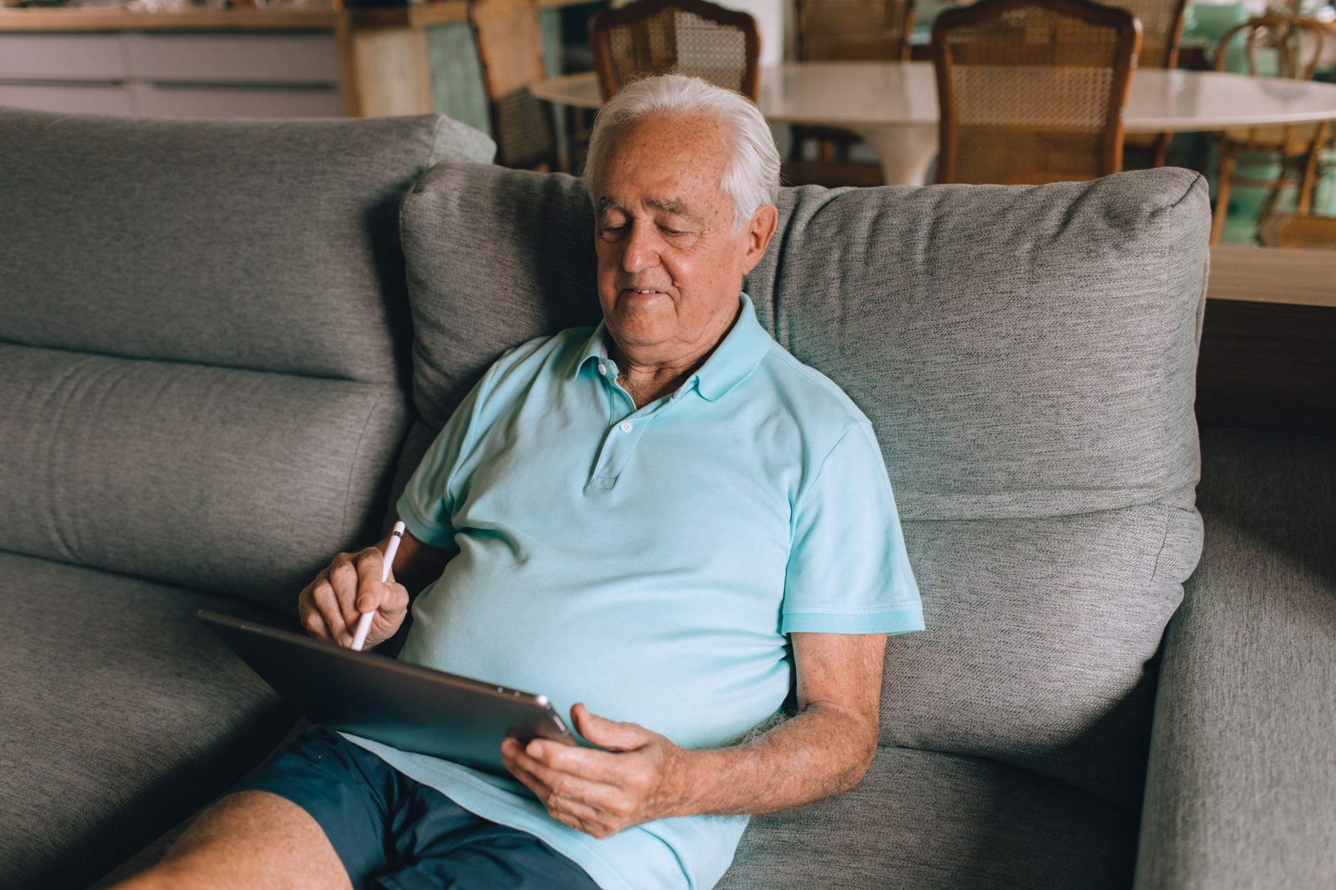 Senior citizen learning tablet settings confidently