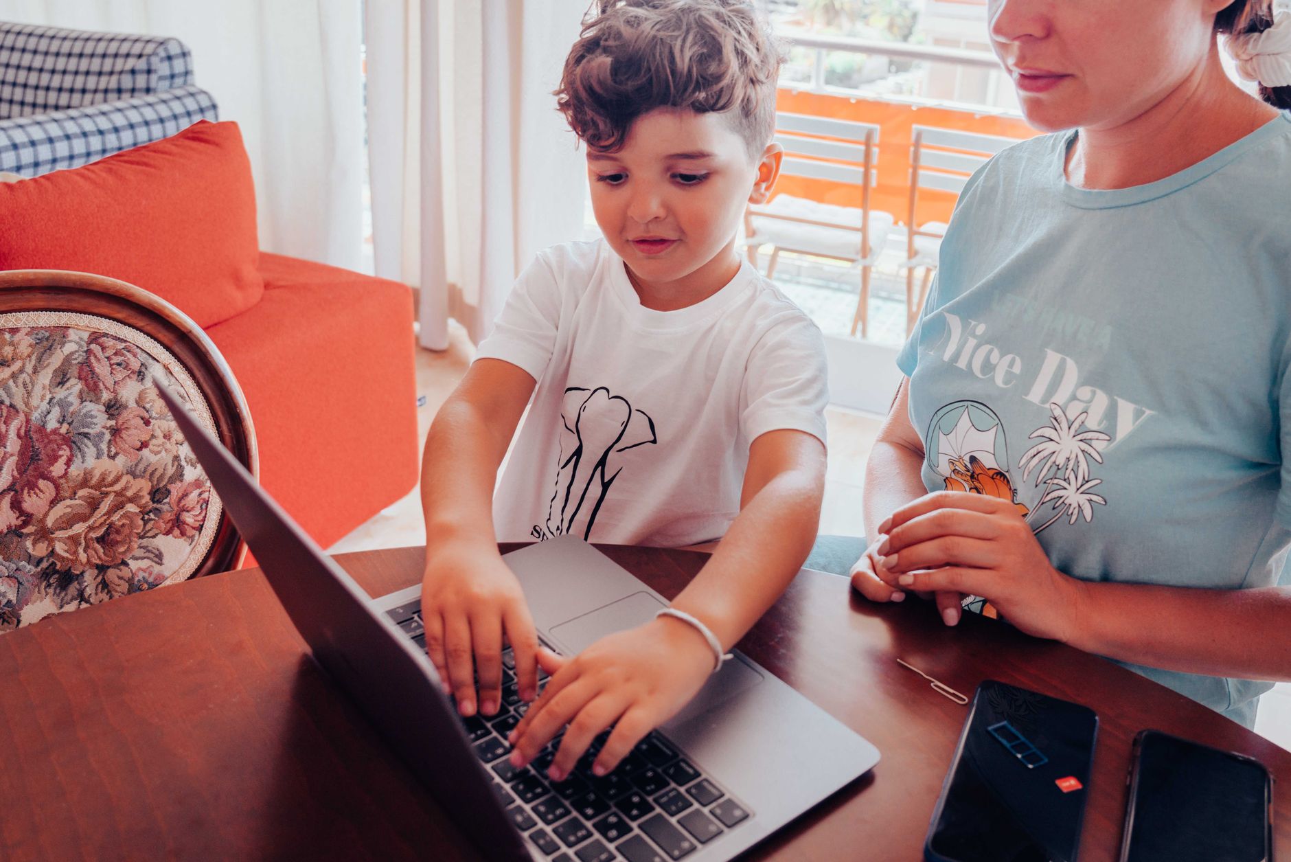 Mother and son using laptop with safety configurations